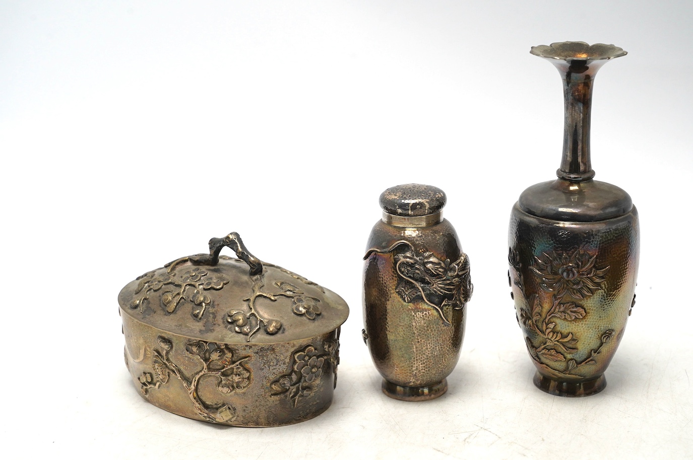 An early 20th century Japanese oval white metal box and associated? cover, 10.2cm, together with a similar posy vase, jar without cover and three mounted clothes brushes. Condition - fair to poor